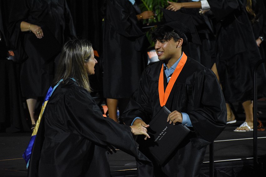 Assistant Principal Lindsay Gallof greets Lorenzo Romani