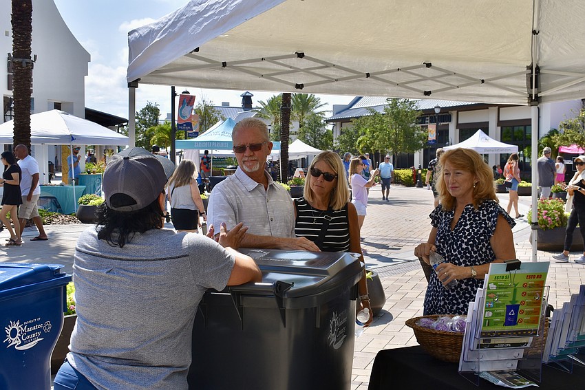 A steady stream of residents stop by Manatee County's booth to ask questions about the impending changes to garbage service.