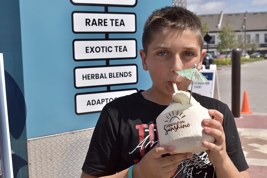 Lakewood Ranch 9-year-old Leo Trupiano cools down with a coconut water.