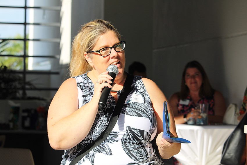 Jaime Limoges, the new membership coordinator at the Longboat Key Chamber of Commerce, updates attendees on upcoming activities.