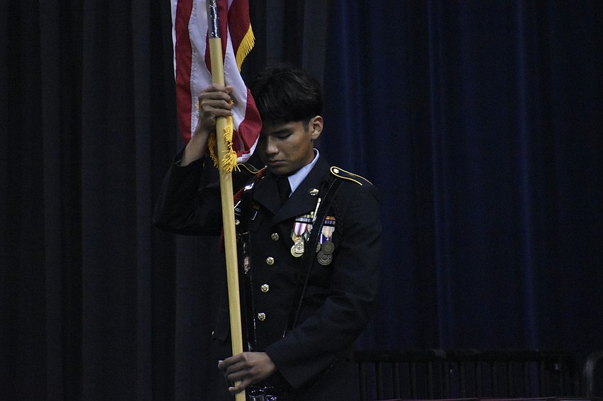 Dasiel Rodriguez of the JROTC Color Guard helps initiate the ceremony.