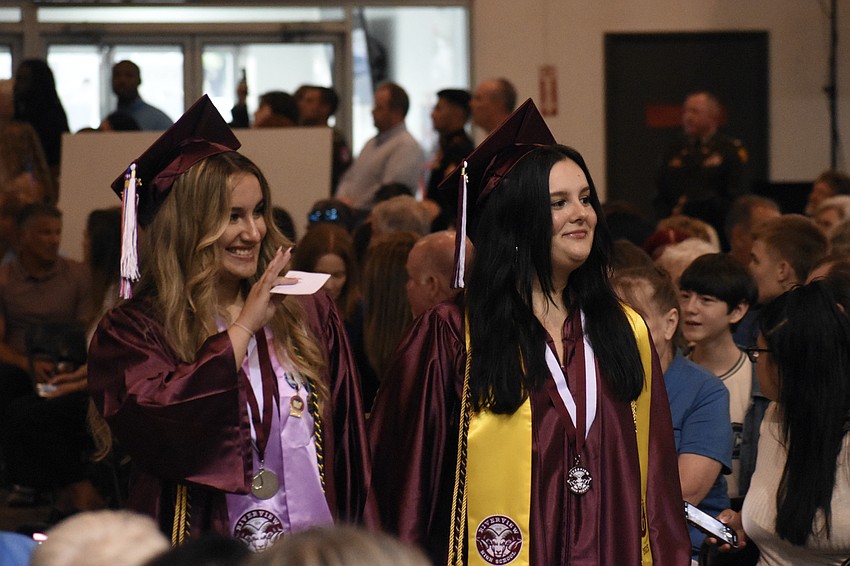 Class president Sophia Bruno Alves and Treasurer Leila Hamzic walk the aisle.
