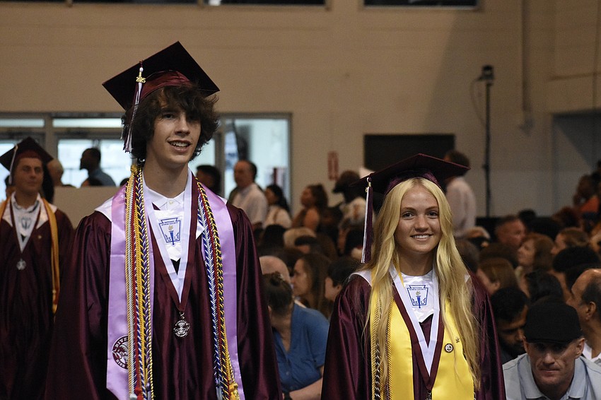 Hudson Moore and Mia Caroline Merandi walk the aisle.