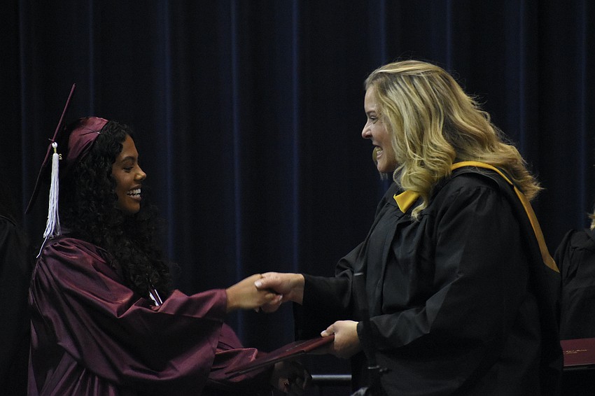 Anna Lopes greets school board member Liz Barker.