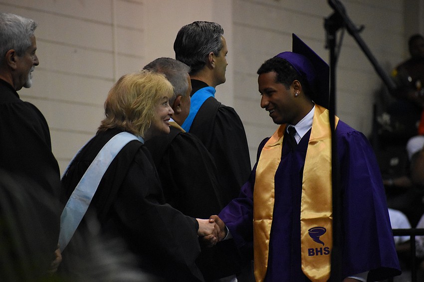 Jose Aponte Garcia shakes hands with School Board member Robyn Marinelli.