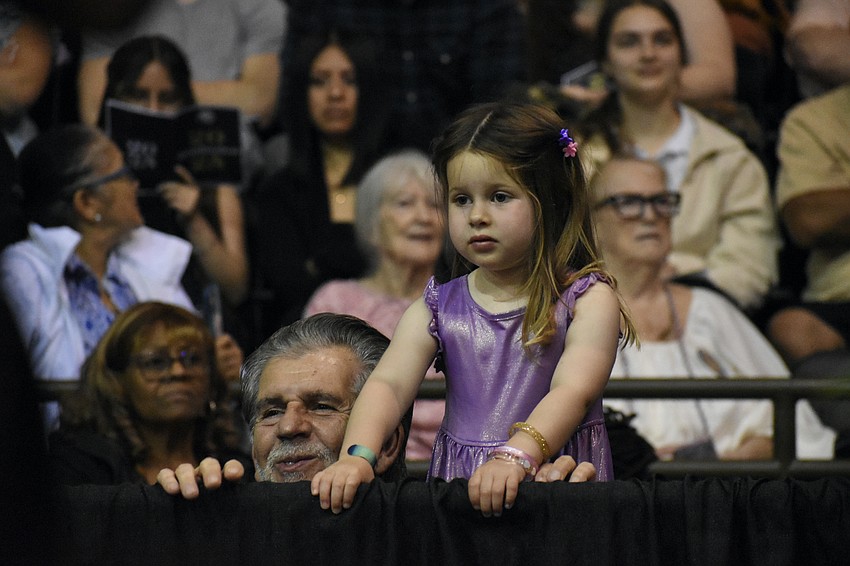 Celso Martini and his granddaughter Sofia Emilia Goeth, 3, prepare to greet his granddaughter Yasmine Carr.
