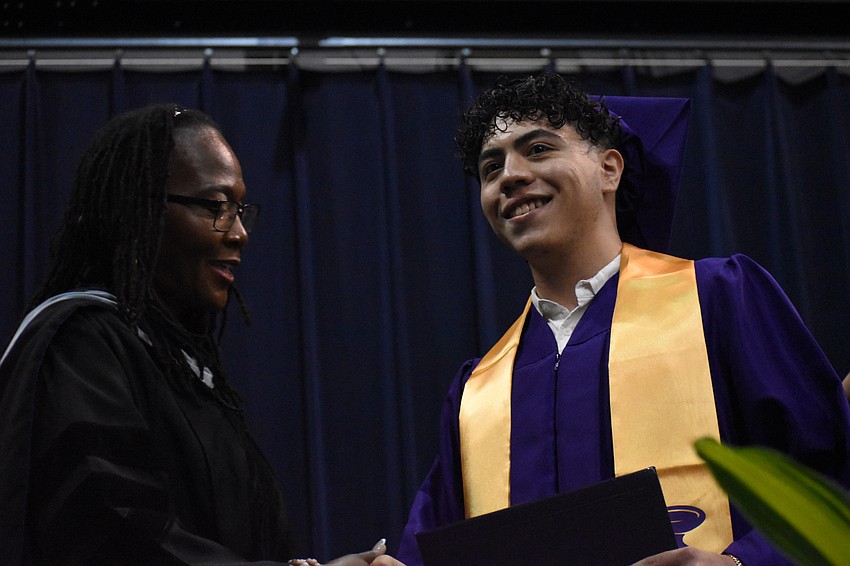 Principal Rachel Shelley greets Yanmanuel Ramos