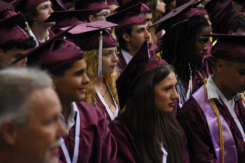 Students listen to a speaker.