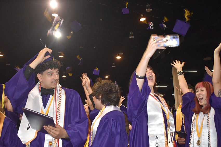 Students including Alexander Edefri, Anthony De La Cruz-Briseno, Fiona Curie and Yasmine Carr, throw up their caps.