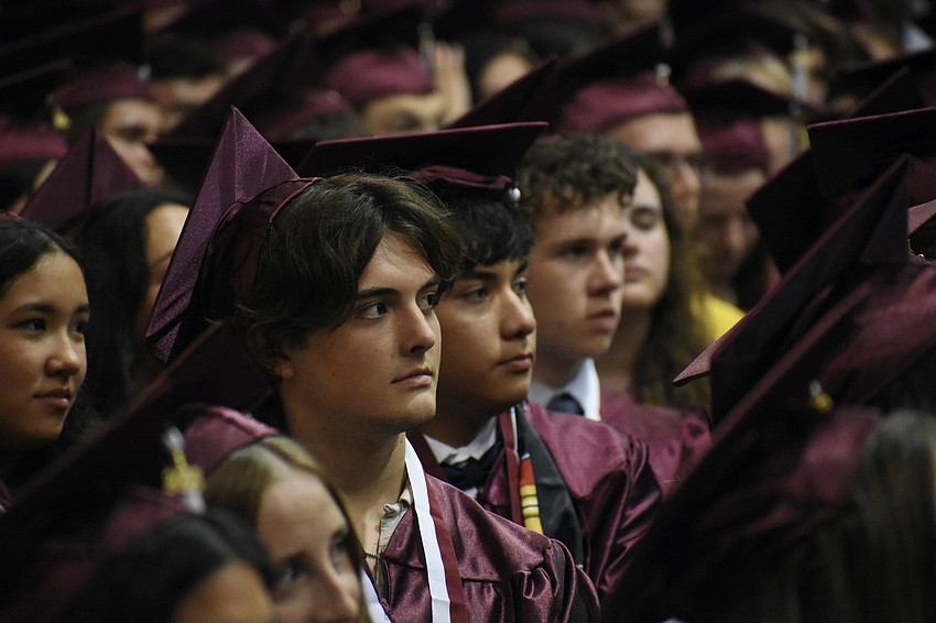 Students, including Gavin Beachy (front), watch the ceremony.
