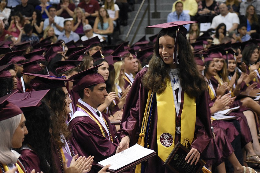 Sara Blake returns from the stage after being the student to receive the Linda Nook Leadership Award and Scholarship.