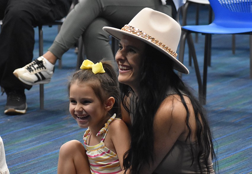 Lakewood Ranch residents Georgia Pinto, 5, and Katie Pinto follow along in the story of 