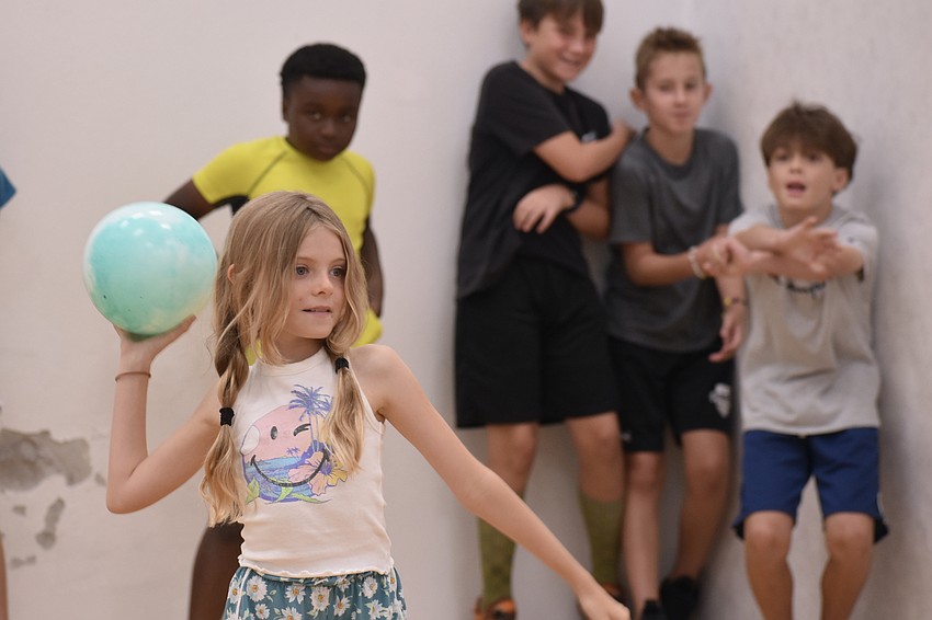 Emery Poucher 9, tosses a ball as Caleb curry, 9, Levi Siljestrom, 10, Dane Radakovich, 10 and Orin Hilliker, 10, look on.