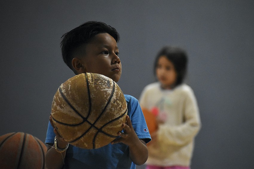 Gabriel Vazquez, 6, throws a basketball.