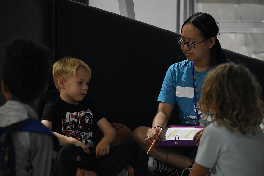 Christopher Wamil 6, talks to counselor Lia Truedinger.