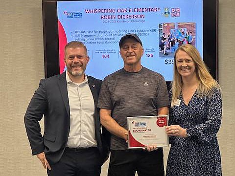 Whispering Oak Elementary and physical education teacher Robin Dickerson(center) was recognized for their participation in the Kids Heart Challenge, earning top rankings and the Heart of Gold Award from the American Heart Association.