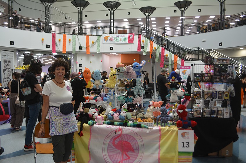 Camille Feaser stands with her booth, Camille's Crochet and is ready for SRQCon.