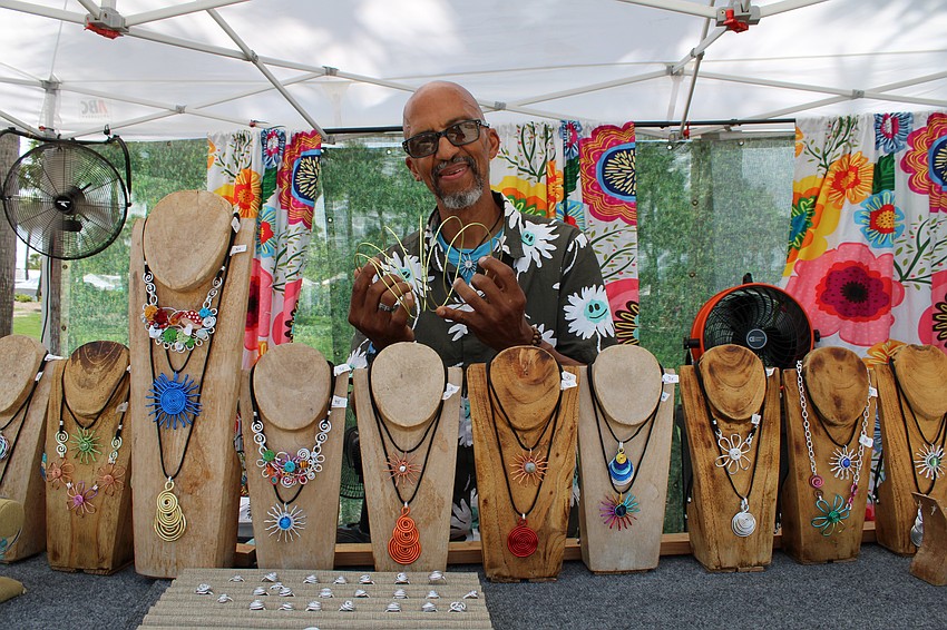 Rob Vega shows the aluminum wiring he uses to craft his lightweight, tarnish-resistant jewelry at last weekend's St. Armands Circle Craft Festival.