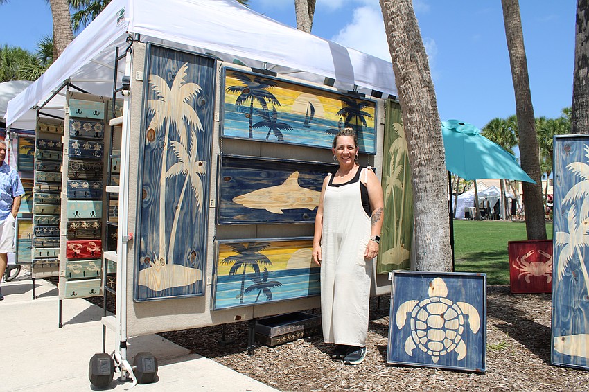 Jennifer Cross, showing her work at the St. Armands Circle Craft Festival, said she appreciates customers' imagination when collaborating on a commission piece. She started crafting her wooden hook racks in her free time during the peak of the pandemic.