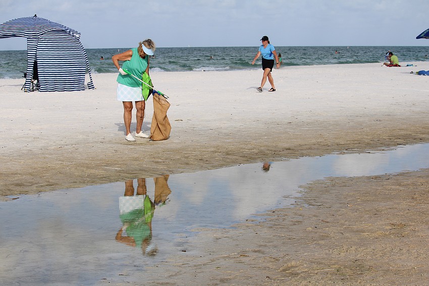 Carol Smith lends a hand with the beach cleanup at Siesta Beach for World Ocean Day on June 8, kicking off a week of events by Mote Marine Laboratory & Aquarium.