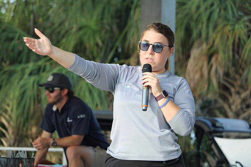 Fiona Bower, the events and programs coordinator at Siesta Beach, shows volunteers which direction to work while cleaning up the shore for World Ocean Day.