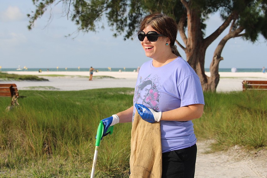 Claudine Waigenfeld patrols the vegetation line for debris at Siesta Beach for World Ocean Day.
