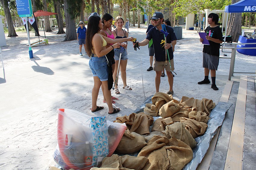 Volunteers turned in their burlap sacks filled with beach litter they collected over the course of the two-hour clean at Siesta Beach.