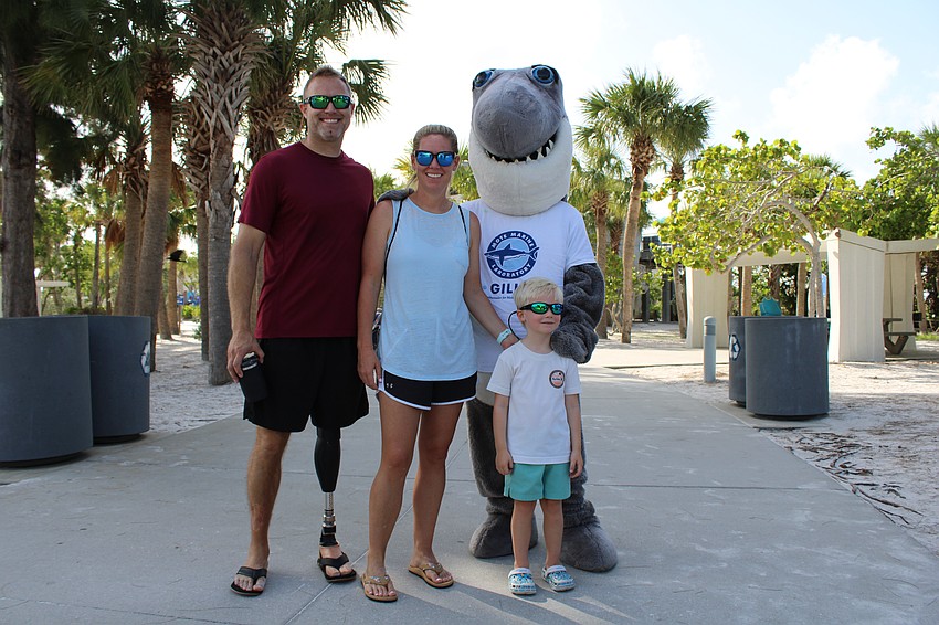 Justin, Carol and Clif Lansford say hello to Gilly at a World Ocean Day event co-hosted by Mote Marine Laboratory & Aquarium on Sunday.