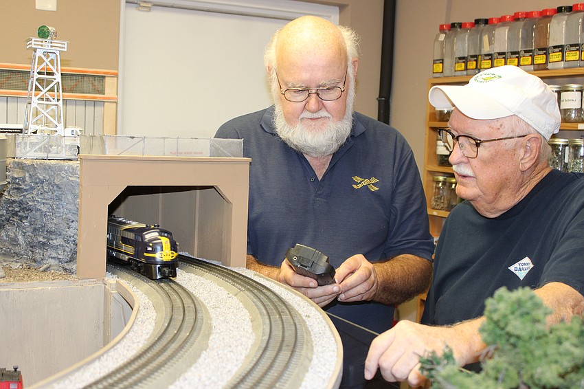RealRail President Allen Novak and club member Doug Neumann work on the O Scale train layout that will be available during the club's special event June 14-15.