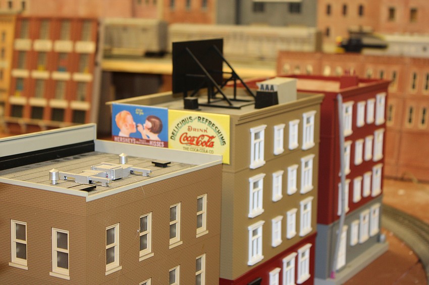 Even miniature buildings in a model railroad layout need advertising.
