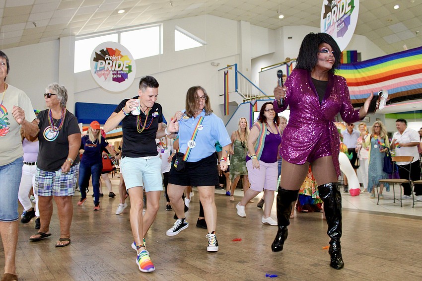 Darcel Stevens leads those on the dance floor in the Electric Slide to the song 