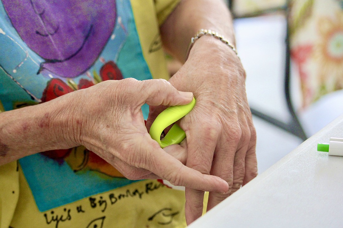 Liz Yerkes, attendee at The Paradise Center's seminar on acupressure, demonstrates how to a tool from AcuMed can be used with the aim of relieving stress.