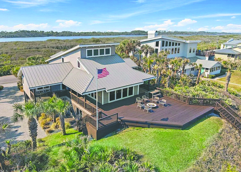 Oceanfront contemporary three-story home features four bedrooms, four bathrooms, gym, porches, deck and dune walkover.