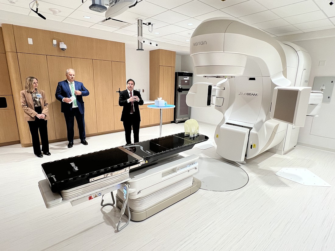 During a June 10 media tour of The Duan Family Building at the Mayo Clinic in Florida, radiation oncologist Dr. Laura Vallow, Dr. Kent Thielen, CEO of Mayo Clinic in Florida, and radiation oncology researcher Chris Beltran show one of the three photon therapy units available to treat cancer patients beginning July 7.