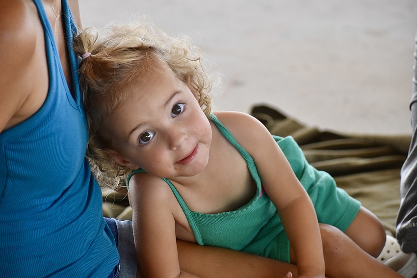 Star Farms' Callaway Roy, 2, takes a break from all the activities in her mom's lap.