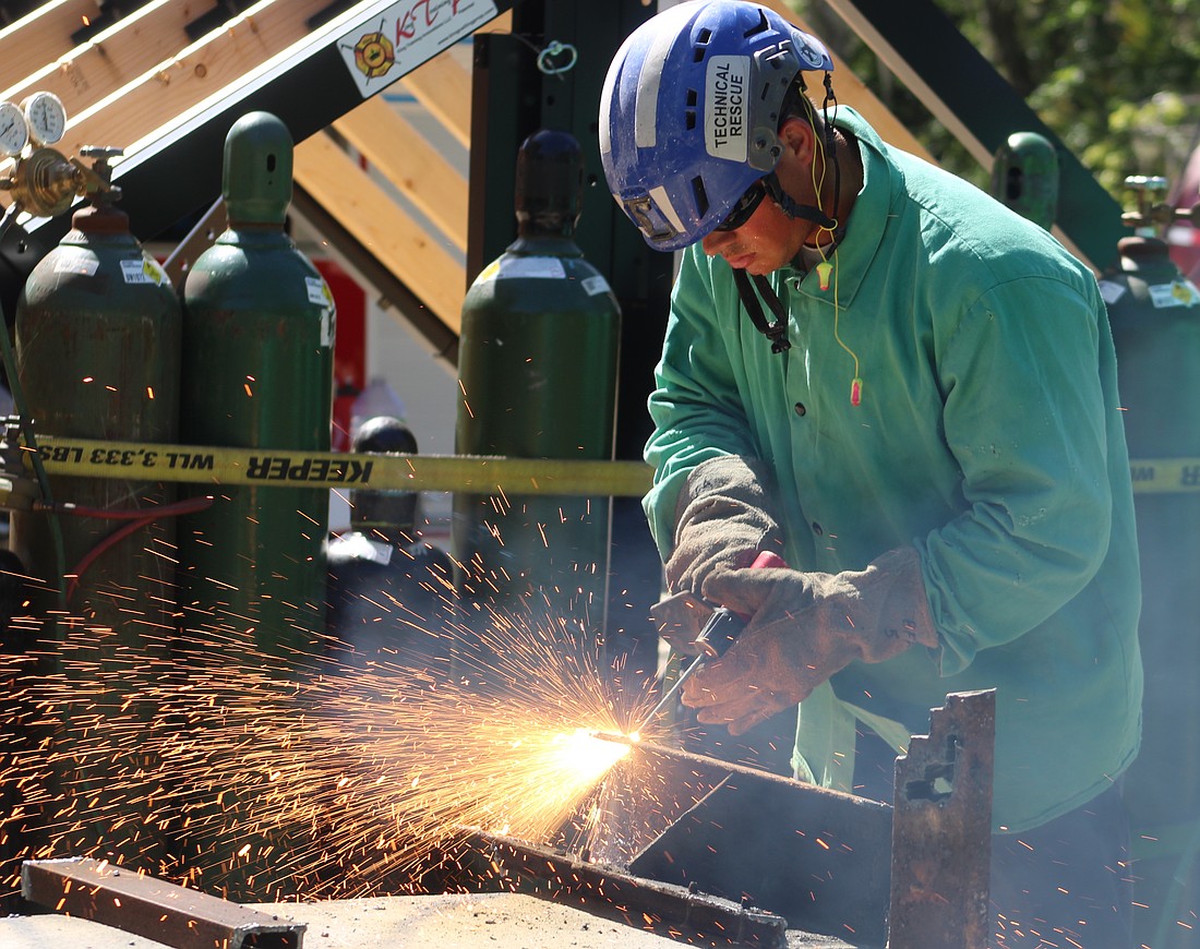 East Manatee Firefighter Larry Haymore practices cutting with a torch during his Technician Level for Structural Collapse training.