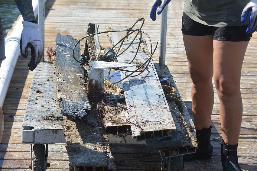 More trash being brought back in from the volunteer diving team.