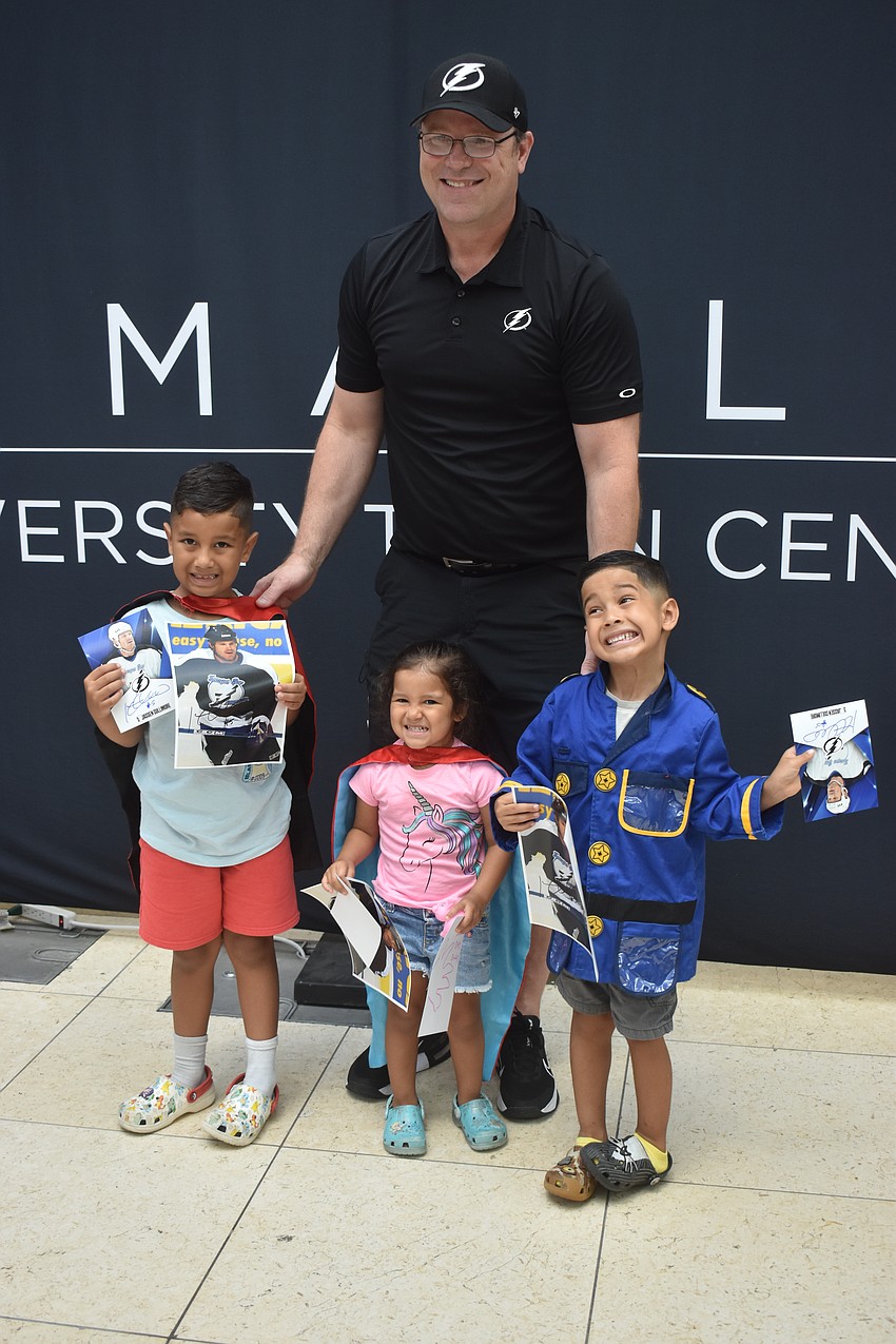 Jassen Cullimore, former Tampa Bay Lightning player, poses for a photo with Grayson, 6, Madison, 3, and Rowan Izaguirre, 4.