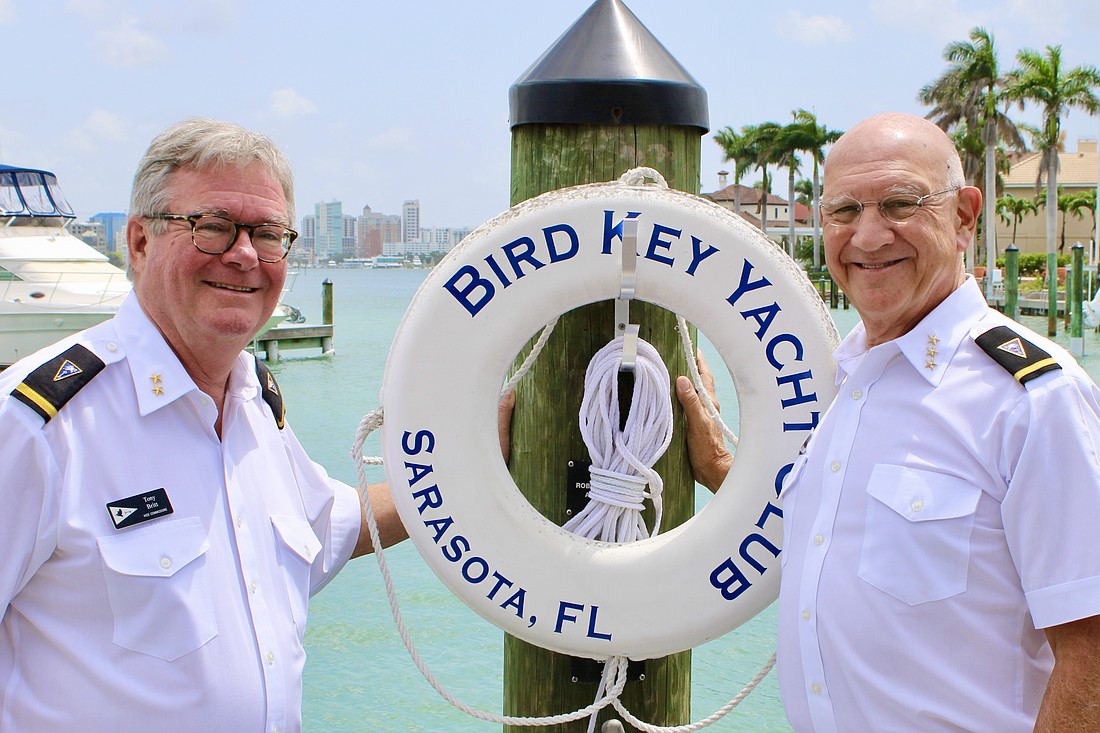 Incoming Bird Key Yacht Club Commodore Tony Britt and outgoing Commodore Michael Landis swap memories and advice in anticipation of the Change of Watch on June 21.