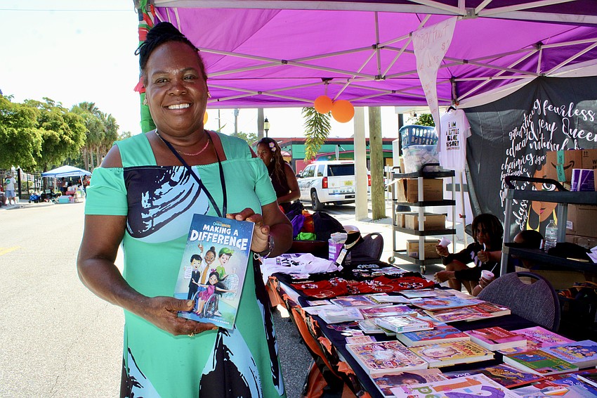 April Glasco, CEO and founder of Second Chance Last Opportunity, served dual roles at the Juneteenth block party, sharing resources like children's books and promoting her new venture, Lady's G Soul Food.