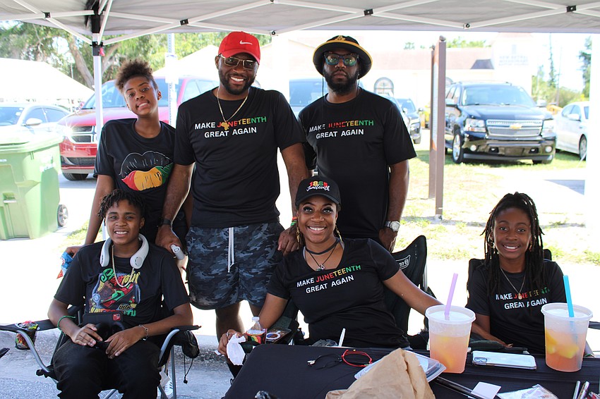 Volunteers help event coordinator Gwendalyn Fleetwood, center, host the sixth annual Juneteenth block party.