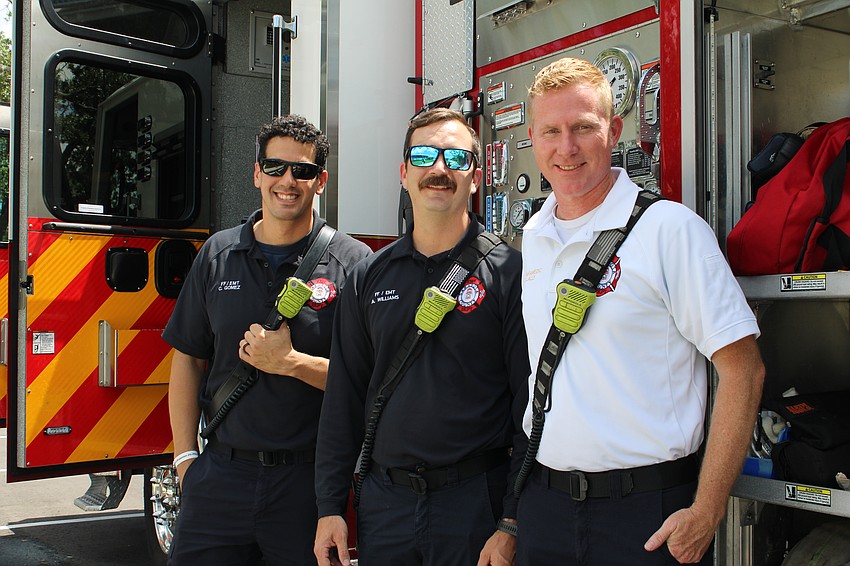 Carlos Gomez, Aaron Williams and Darren Lally from Sarasota County Fire Department Station 5 give attendees at Diverse Fest the grand tour of their engine.