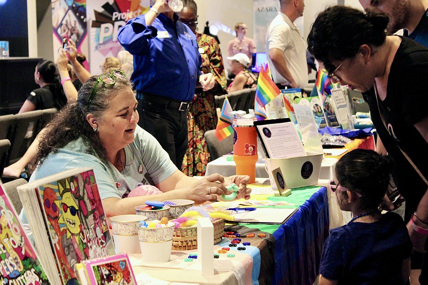 Elena Torres Biset, owner of Creative Coaching, chats with visitors at Diverse Fest.