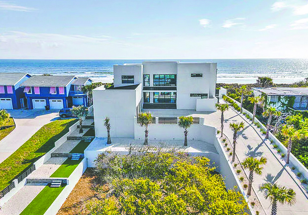 Oceanfront two-story contemporary home built in 2024, features four bedrooms, four full and one half-bathrooms, porches, pool and dune walkover.