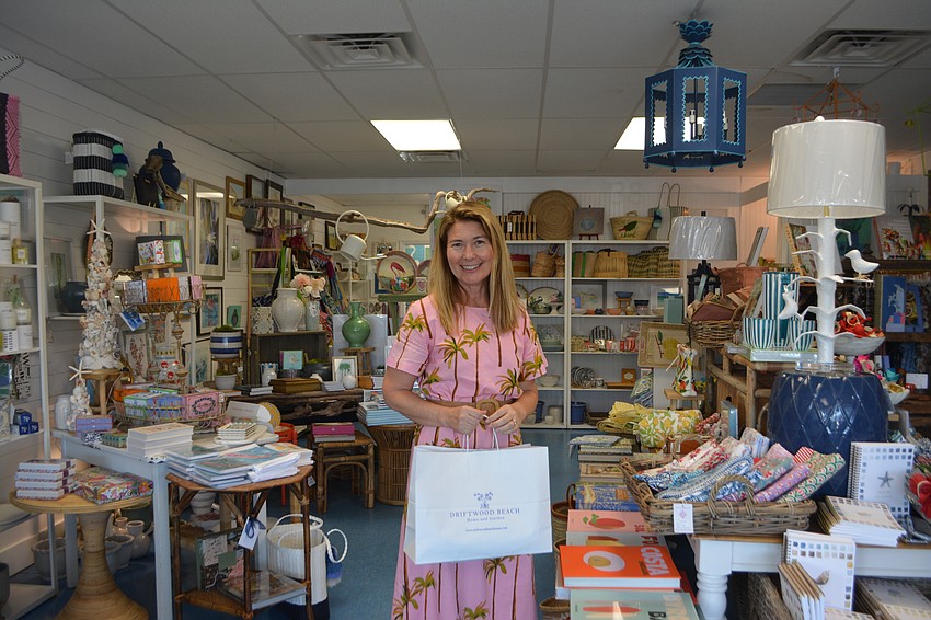 Heather Rippy, owner of Driftwood Beach Home and Garden poses after a successful first of the Season Summer Night Out.
