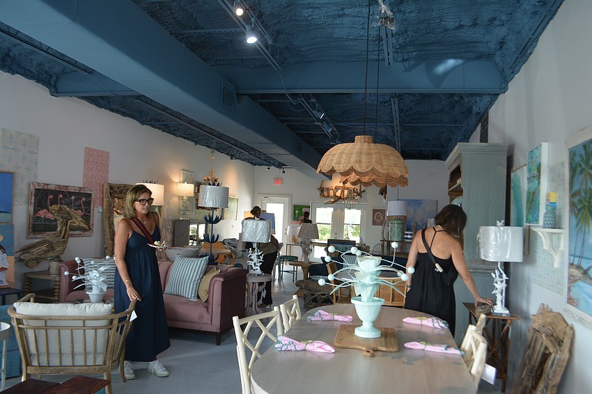 Residents gather to look at the showroom thats a couple stores down from Driftwood Beach Home and Garden.