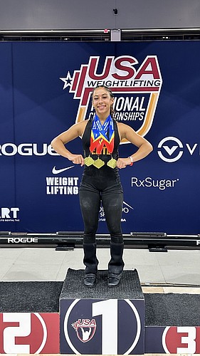 Nya Williams stands on top of the podium on Sunday night, June 22, with her three gold medals at the USA Weightlifting National Championships in Colorado Springs. Courtesy photo