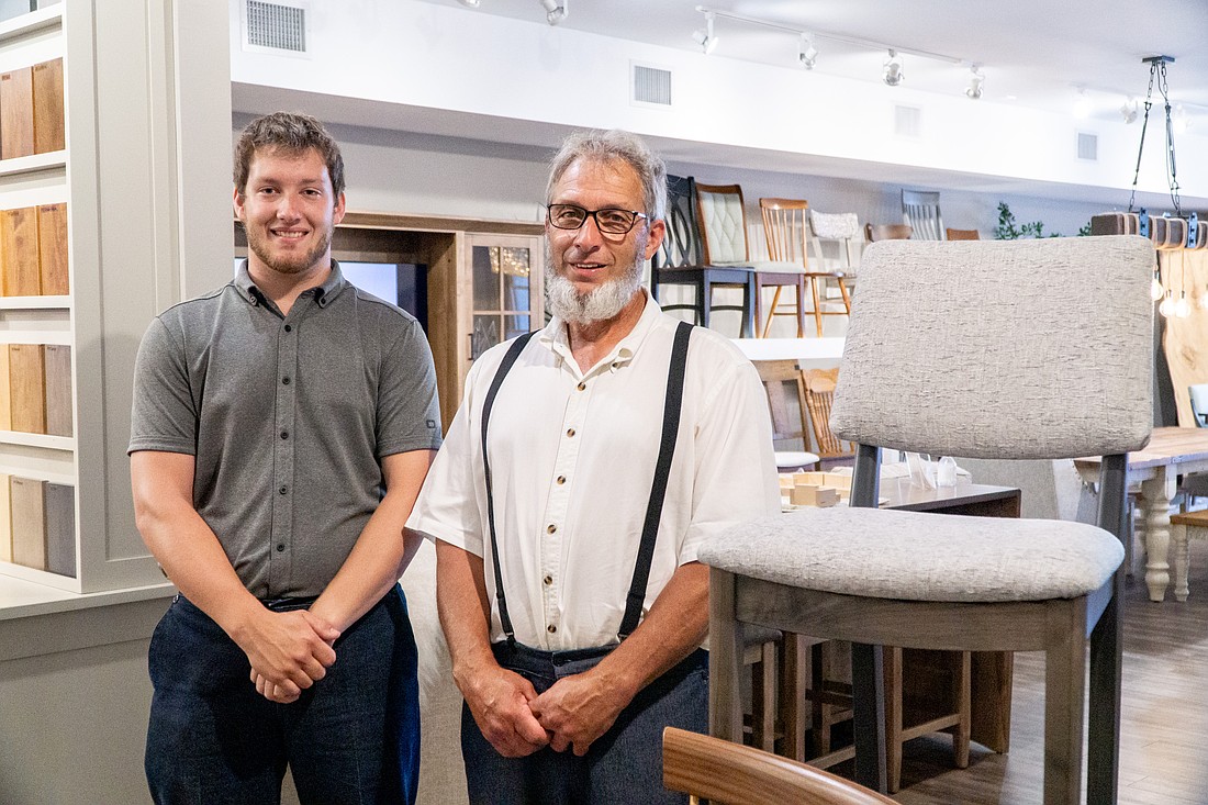 Caleb and Ivan Hochstetler with one of their chair designs featured in DutchCrafters Sarasota showroom.