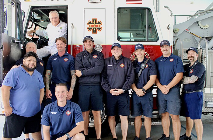Chef José Martinez of Maison Blanche hops in the cab of a fire engine after he and Juan Gomez join the Rotary Club of Longboat Key in preparing a special thank-you lunch to members of Fire Station 2 with Longboat Key Fire Rescue.