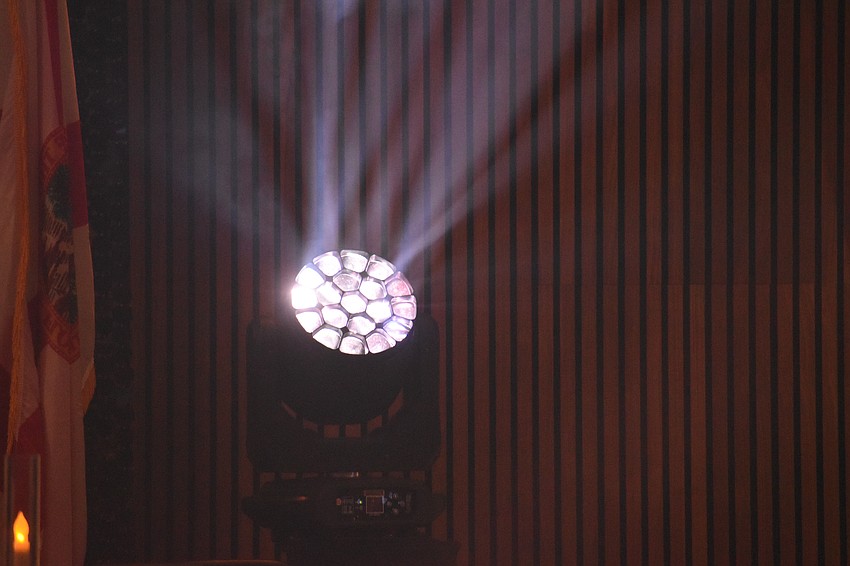A spotlight shines at the event.